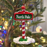 
              The North Pole Sign Covered in Snow Christmas Tree Ornaments
            