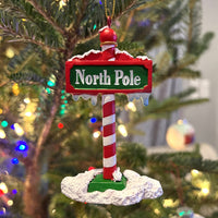 The North Pole Sign Covered in Snow Christmas Tree Ornaments